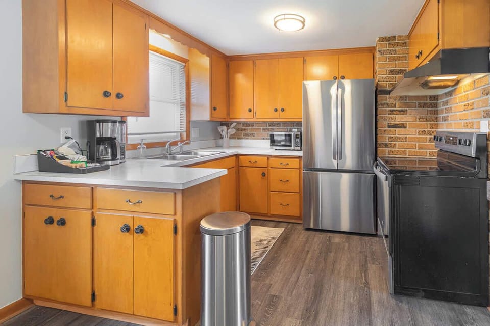 A shot of the kitchen featuring sleek stainless steel appliances, including a microwave for quick meals. A dedicated coffee station adds a cozy touch, perfect for brewing your favorite morning coffee to start the day off right.