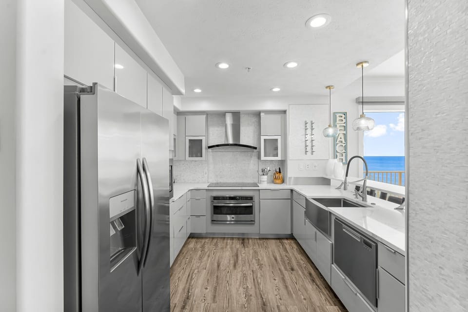 Modern kitchen with stainless steel appliances and ocean views.