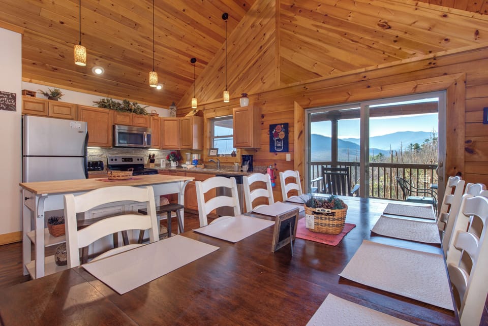 Gather around this rustic dining table where you can enjoy meals while taking in stunning mountain views through the large windows.