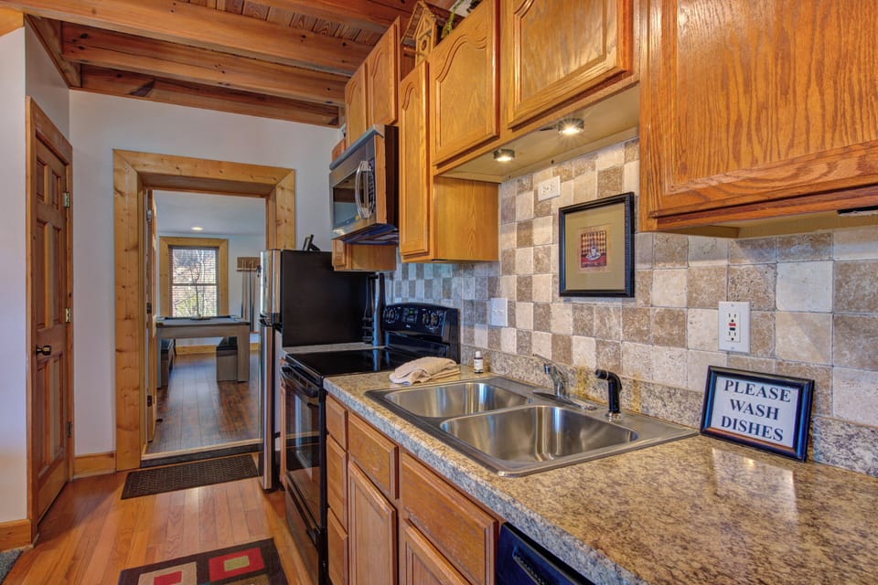 Your fully equipped kitchen features granite counters, stone backsplash, and everything needed to prepare memorable meals during your mountain getaway.