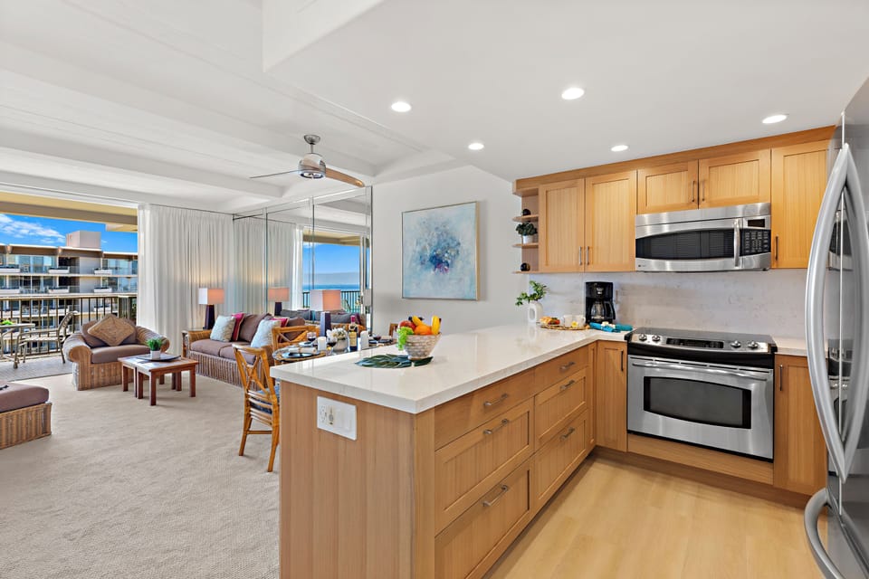 Bright open-concept living with a modern kitchen island flowing into your sunny living area. Watch the ocean through floor-to-ceiling windows as you prep meals or unwind.