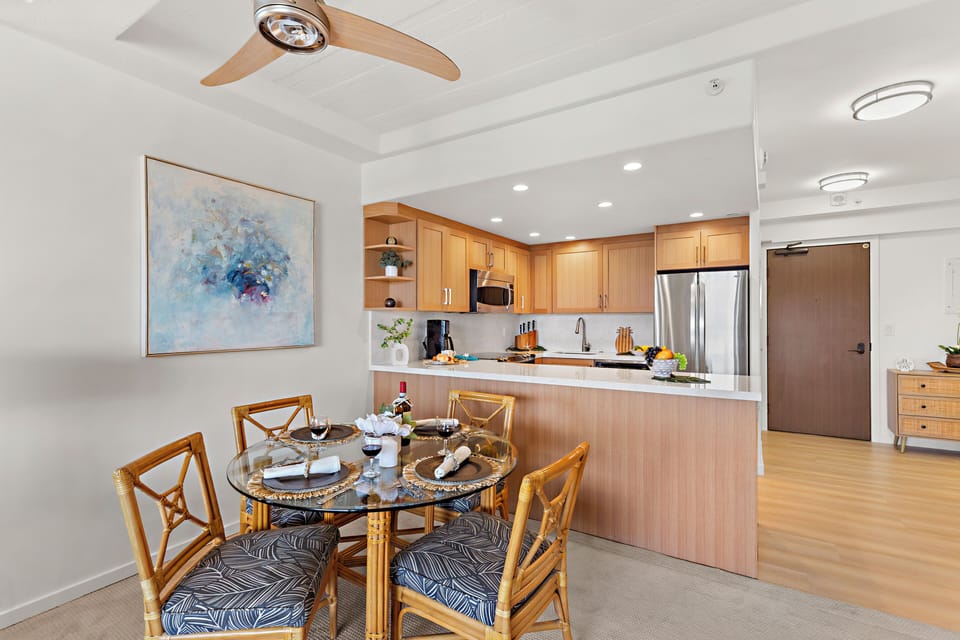 Step into your bright, open-concept living space where a stylish dining area flows seamlessly into a modern kitchen. The warm wood tones and sleek finishes invite you to settle in and feel at home.
