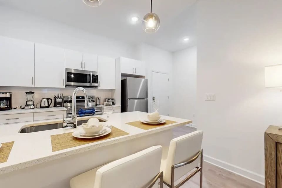 Cook with ease in a fully stocked kitchen featuring all the appliances you need, including a fridge, stove, and more!