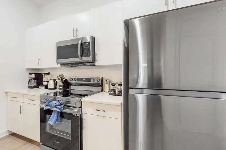 Cook with ease in a fully stocked kitchen featuring all the appliances you need, including a fridge, stove, and more!