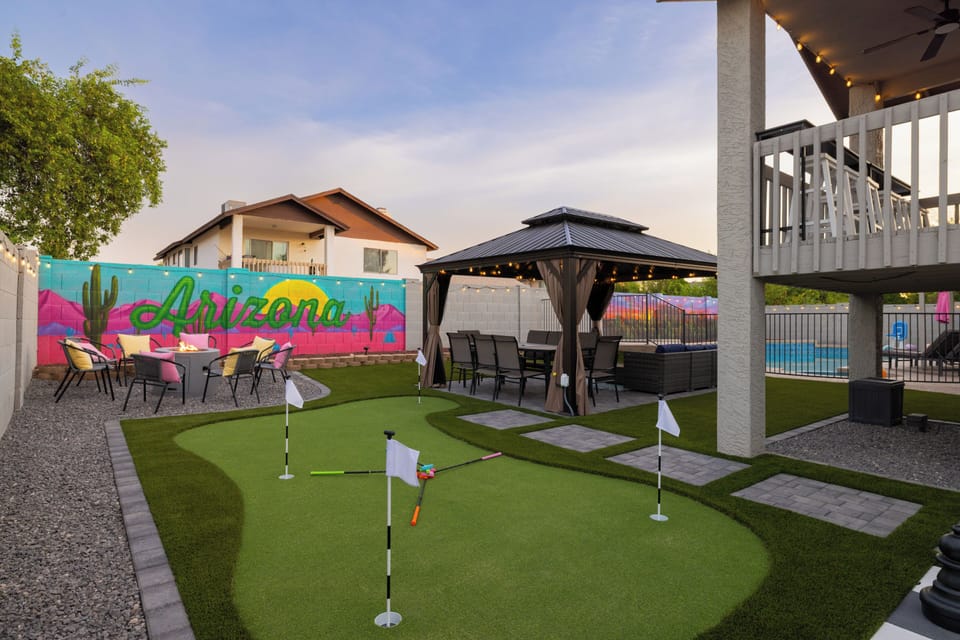 Private backyard oasis with mini golf, pergola, and fire pit