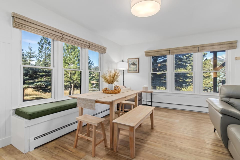 Sunlit dining nook with scenic window views