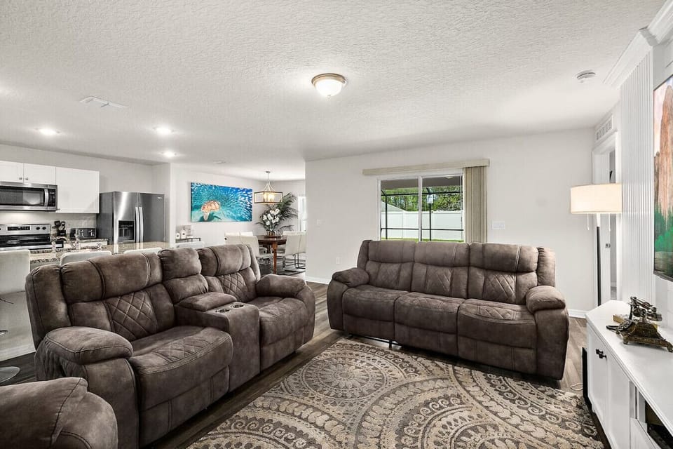 Bright and airy living space with comfortable seating and a large smart TV