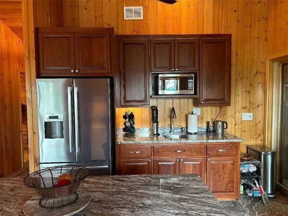 Breakfast bar, second sink and refrigerator with ice and water dispenser.