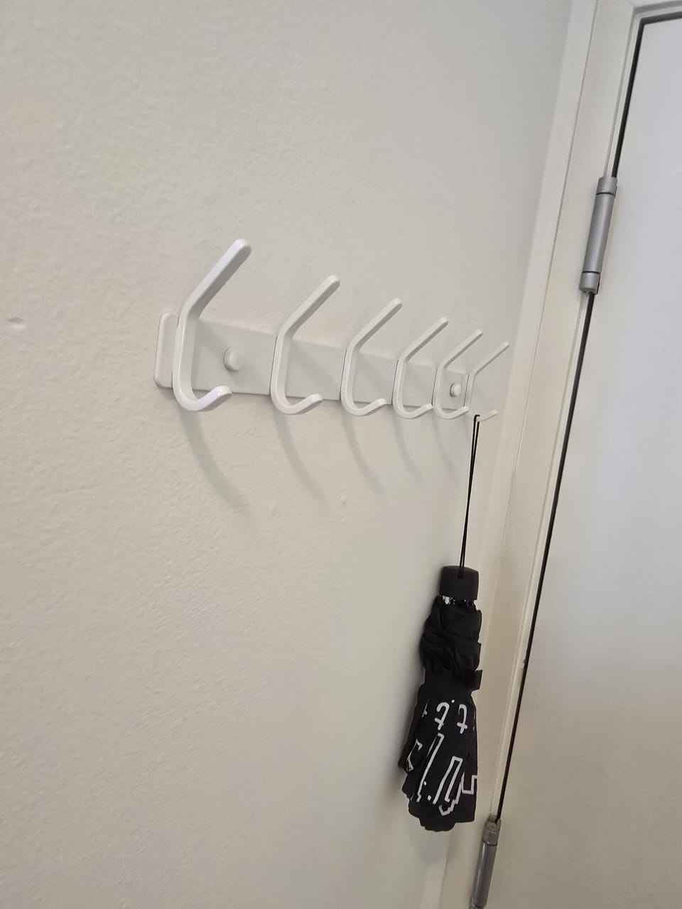 Entry hooks with complimentary umbrella for rainy-day convenience