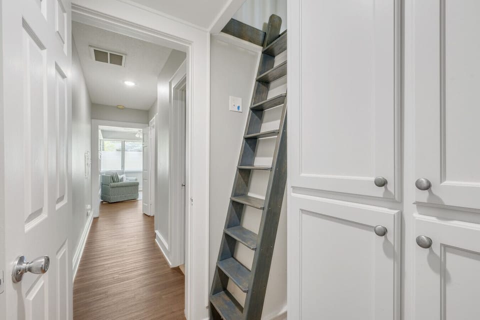 Hallway off the primary bedroom with ample storage and loft