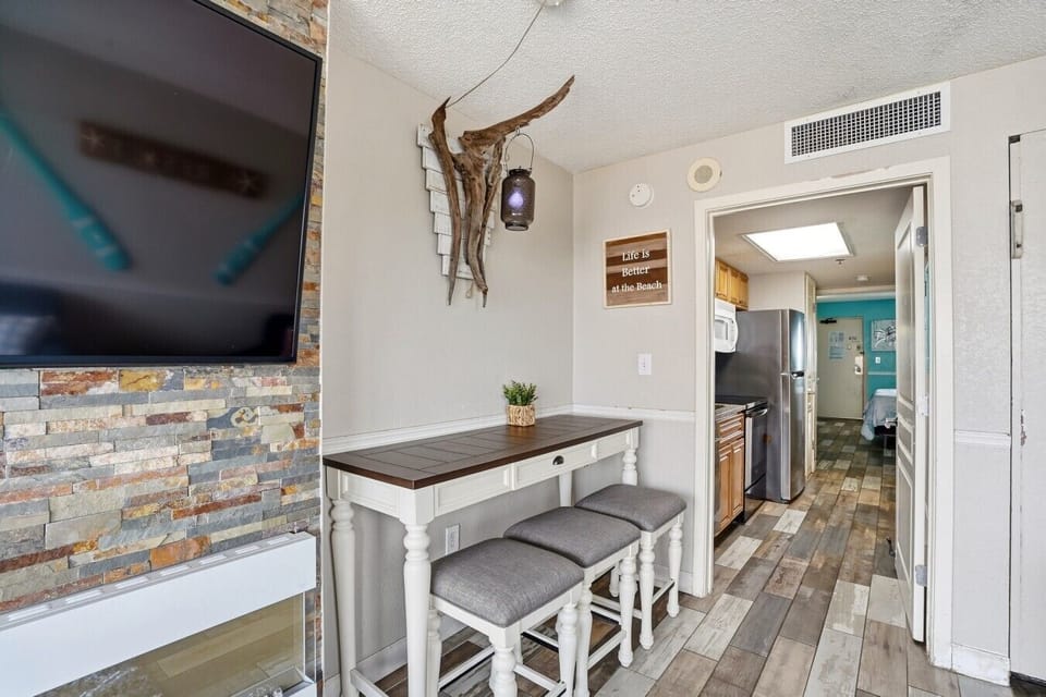 The dining nook offers a comfortable space for 3 to enjoy meals or play games. Conveniently located next to the living area, it also serves as extra seating for families or guests, making it ideal for group stays and shared moments.