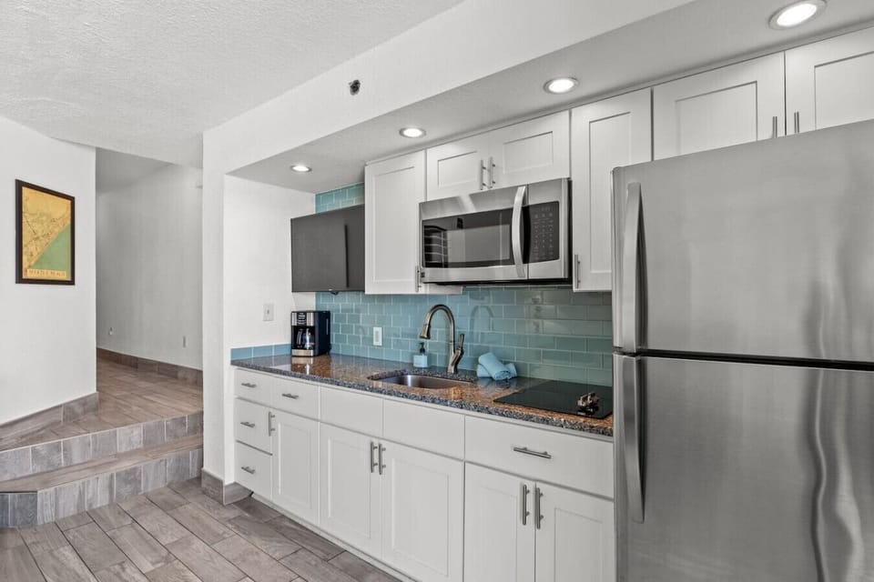 This kitchen is perfect for whipping up a family meal during a beach vacation.  The Ocean Decor adds to the flavor of this gorgeous kitchen which has a refrigerator, Smart TV stovetop burners, sink, microwave and plenty of cabinet space.