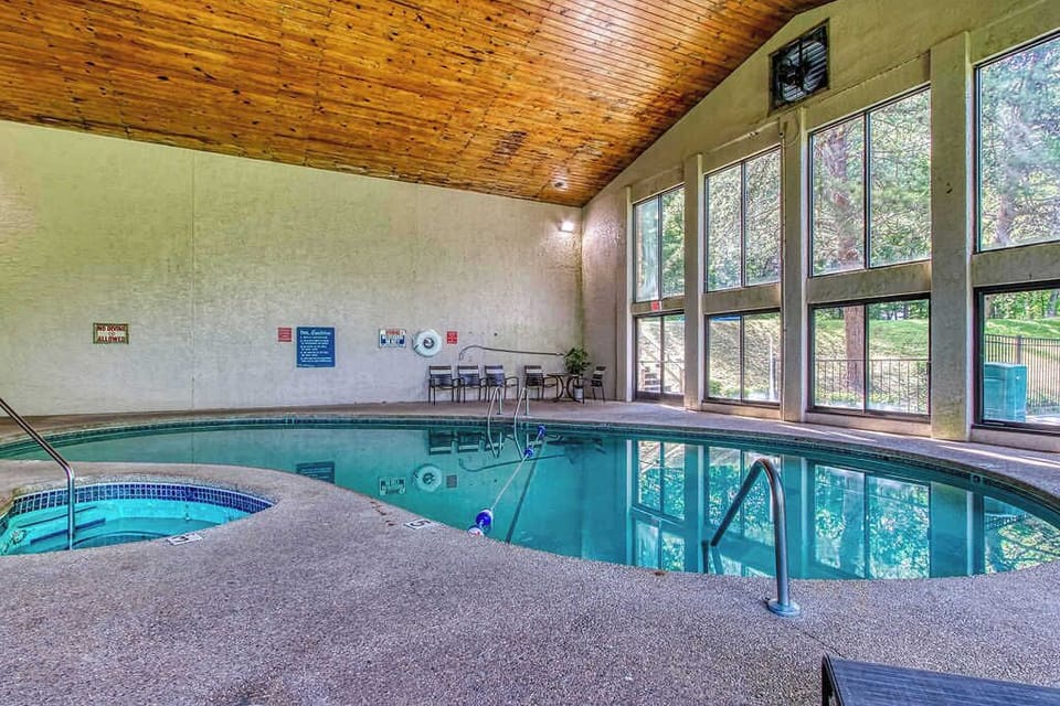 A serene pool area invites you to take a refreshing dip. 

🚨 The hot tub in the pool area is NOT operational. Please do not book expecting a hot tub, as it is not listed as an amenity. 