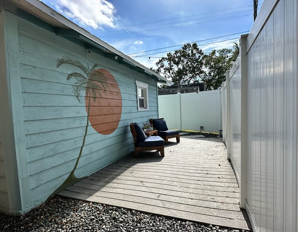 Private patio area with comfortable outdoor seating and string lights.