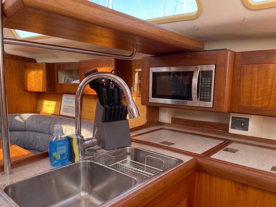 Galley sink and counter space framed in classic teak woodwork

