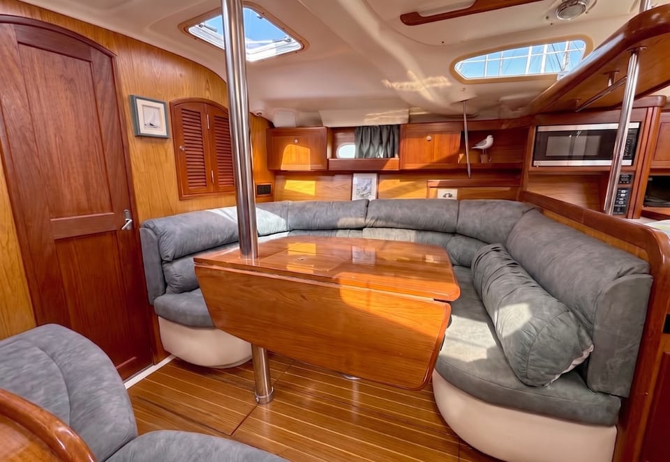 Warm wood saloon with cushioned seating and a dining table for the group
