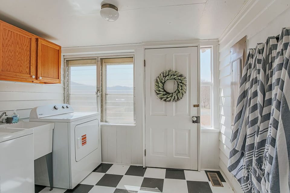 Laundry room with a new washer and dryer for guest use