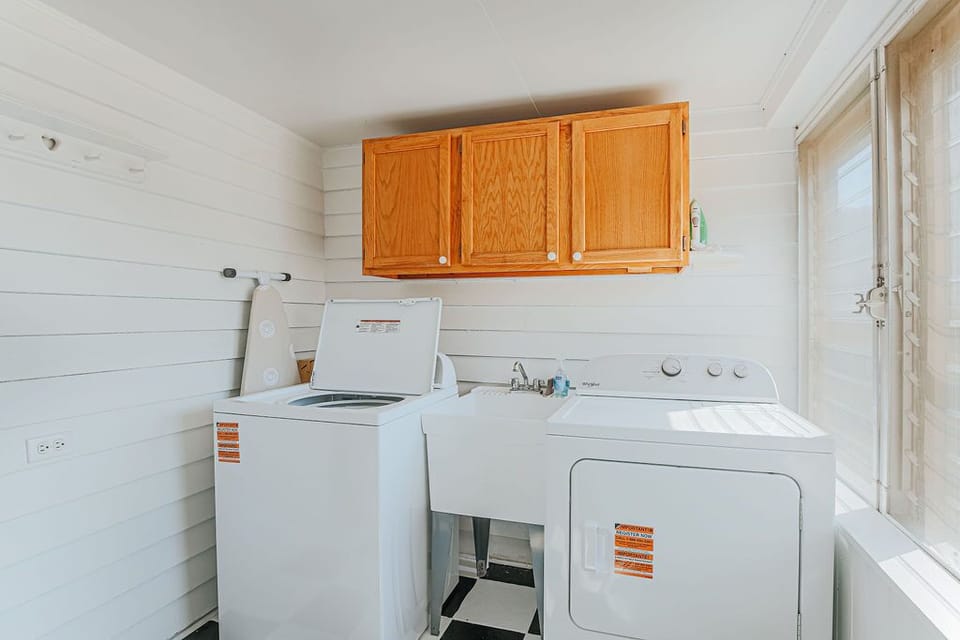 Laundry room with a new washer and dryer for guest use