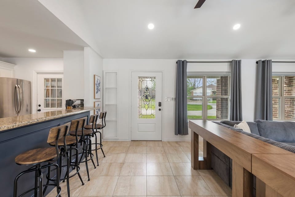 Bright open entry with bar seating and cozy living space.