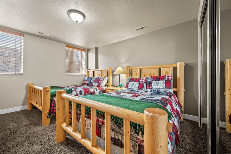 The third bedroom exudes mountain charm with rustic bedspreads and beautiful pine beds.