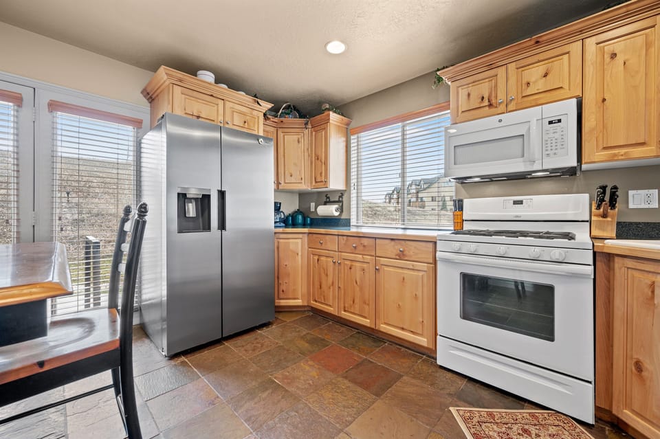 A gas stove, microwave, and a large refrigerator with an ice maker make it perfect for the gourmet chef.