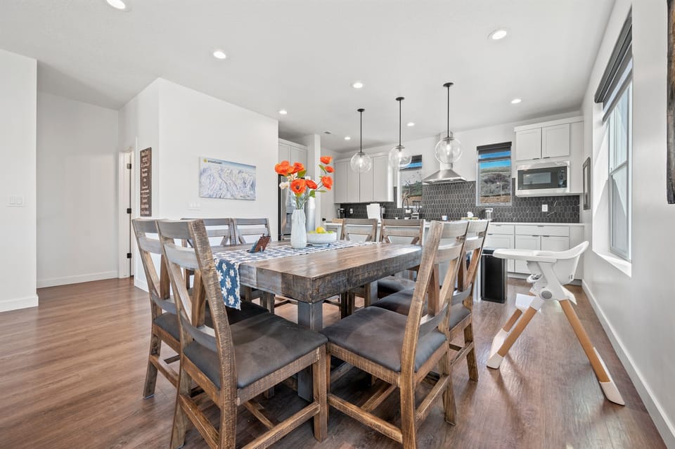 Recessed lighting, lamps, and abundant natural light from the windows make the space feel bright and cheerful.