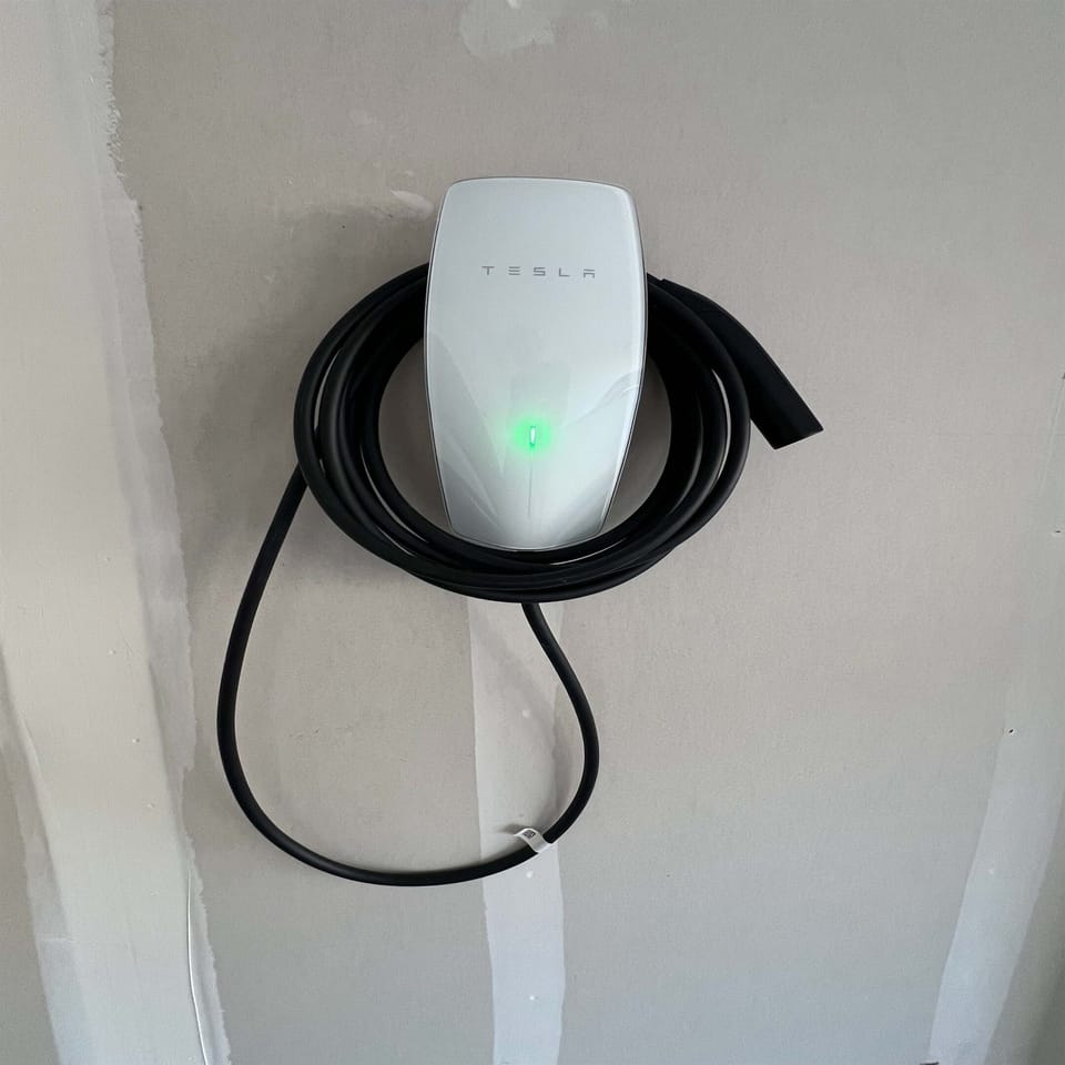 A Free Tesla EV Charger is in the garage