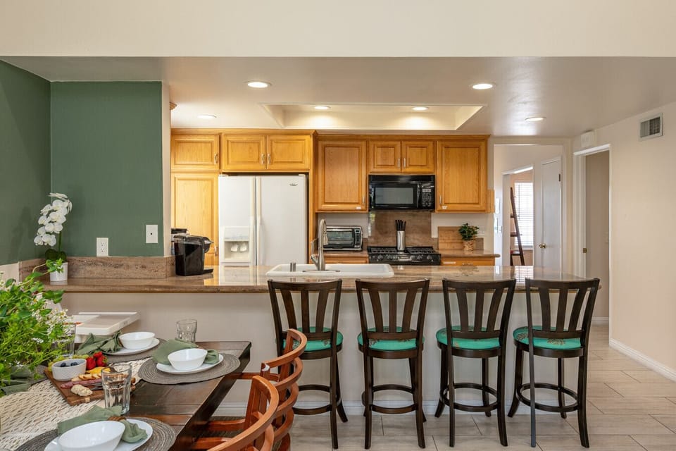 Cook, laugh, and relax in our sunlit open kitchen + living space — designed for connection and comfort.