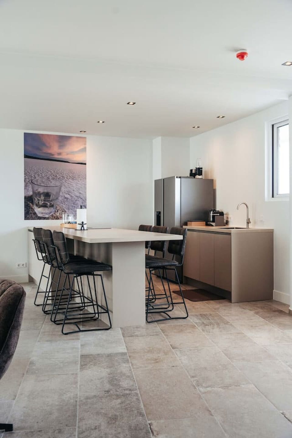 Where modern minimalism meets everyday comfort—sleek counters, cozy bar stools, and a space that’s made for coffee breaks, quick bites, and long chats.
