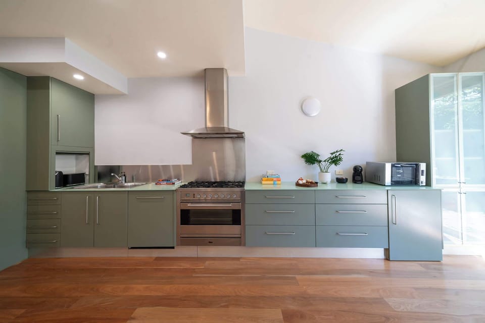Chefs kitchen with all amenities, 6 burner gas stove top, microwave, coffee machine and large pantry with bi fold doors opening up to the garden 