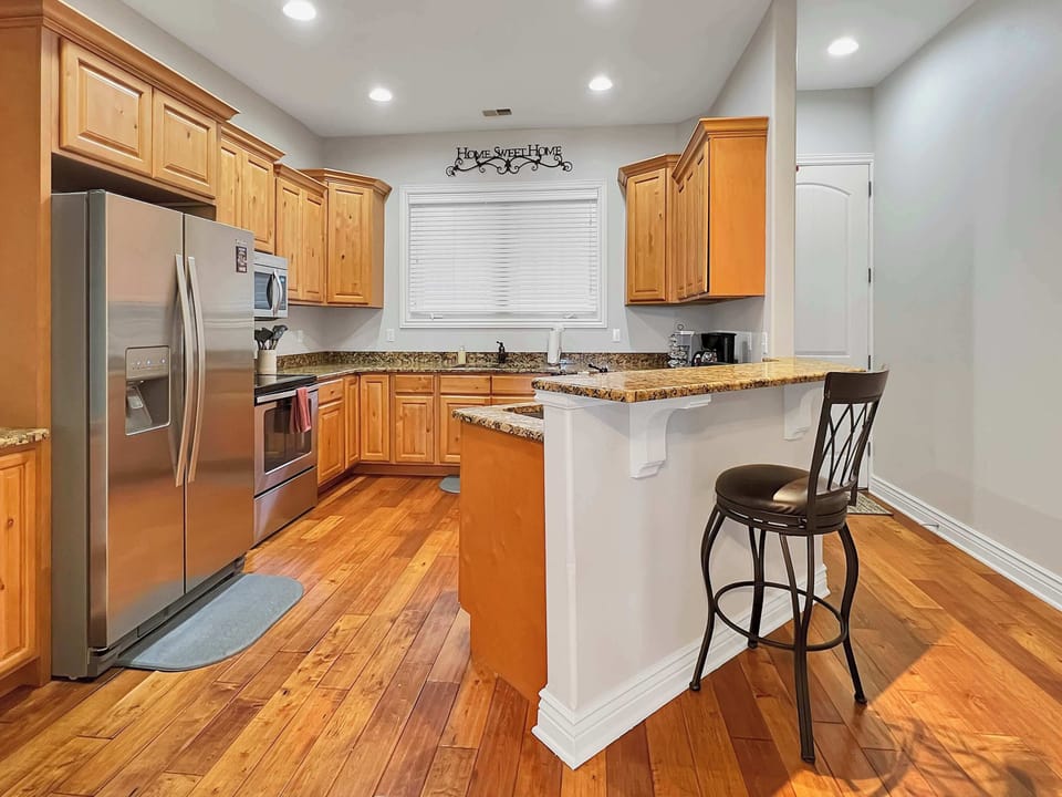 Kitchen with breakfast bar and all of the appliances and amenities you need to make your families favorite meals.