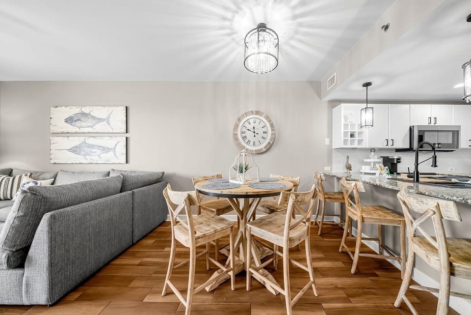 There is a dining table, perfect for enjoying a meal or playing a game, as well as additional breakfast bar seating.