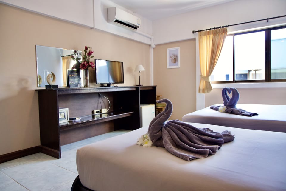 Standard Triple Room | Minibar, in-room safe, desk, bed sheets