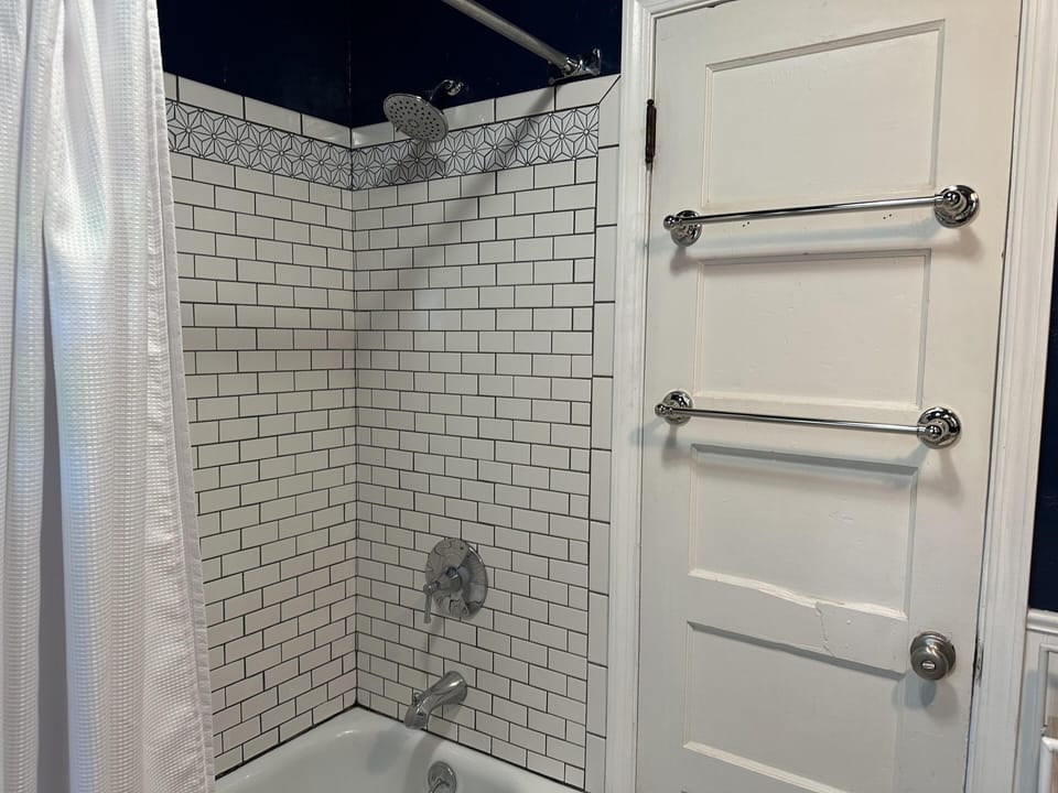 One bathroom in this home with fresh subway tile and a 4ft cowboy bathtub!