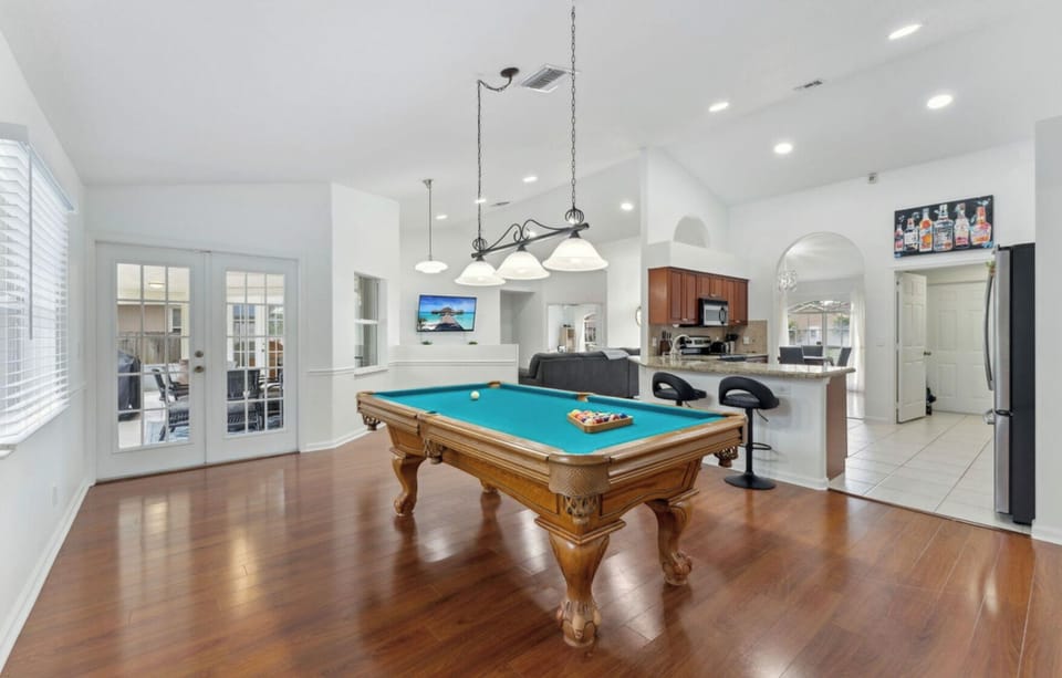 The game room has a stylish pool table and a dart board for hours of fun.
