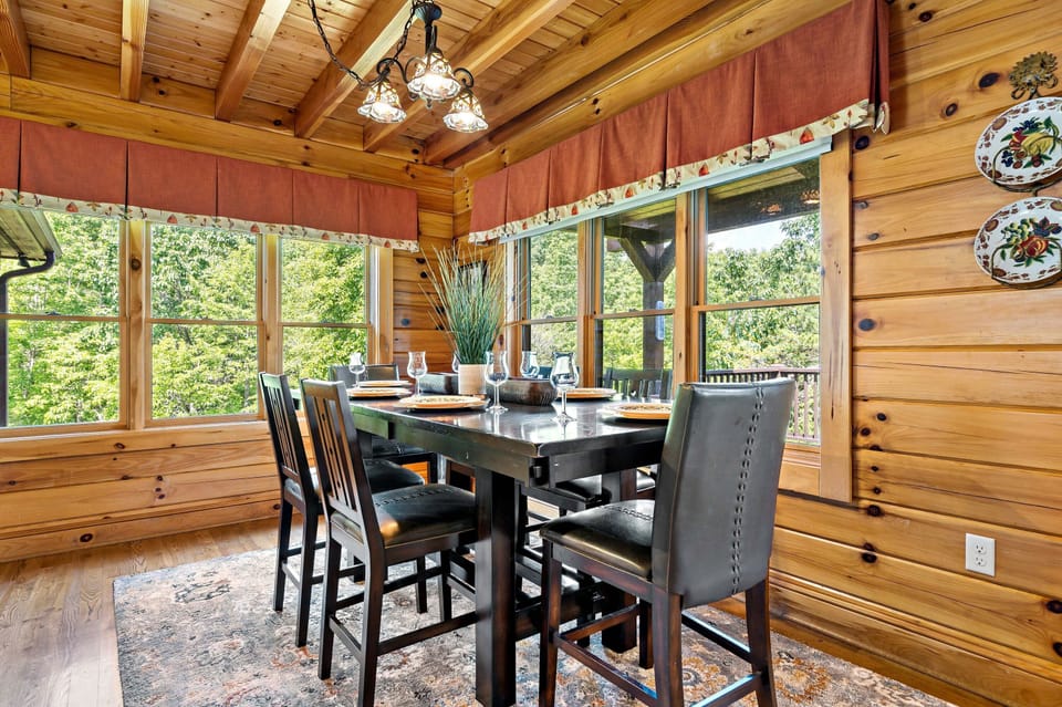 Dining area with seating for 6 and island seating for 3, with additional leaf and seating available