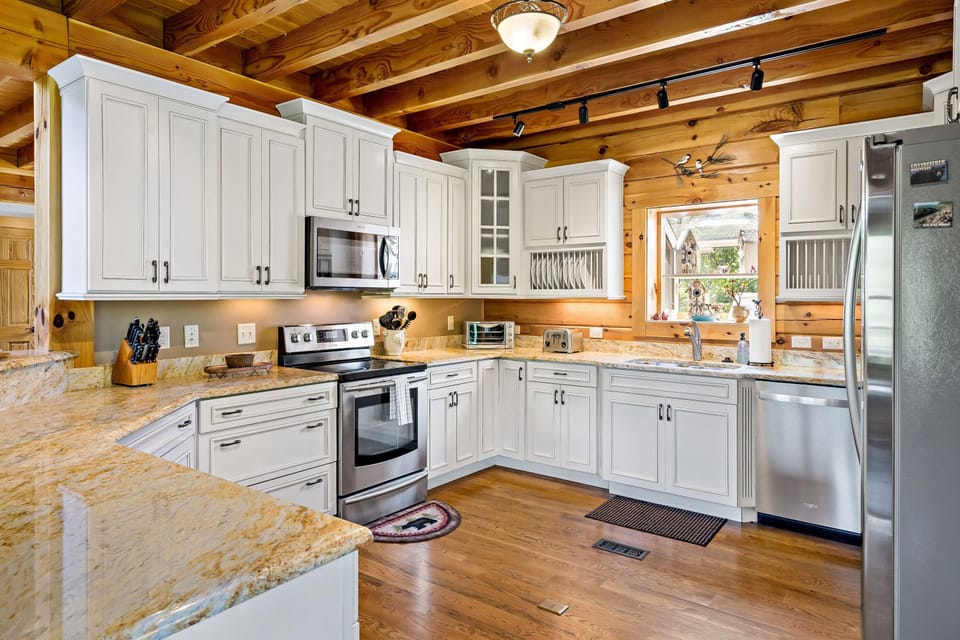 Kitchen with dishwasher, standard drip-style coffee maker, Keurig coffee maker, and coffee grinder