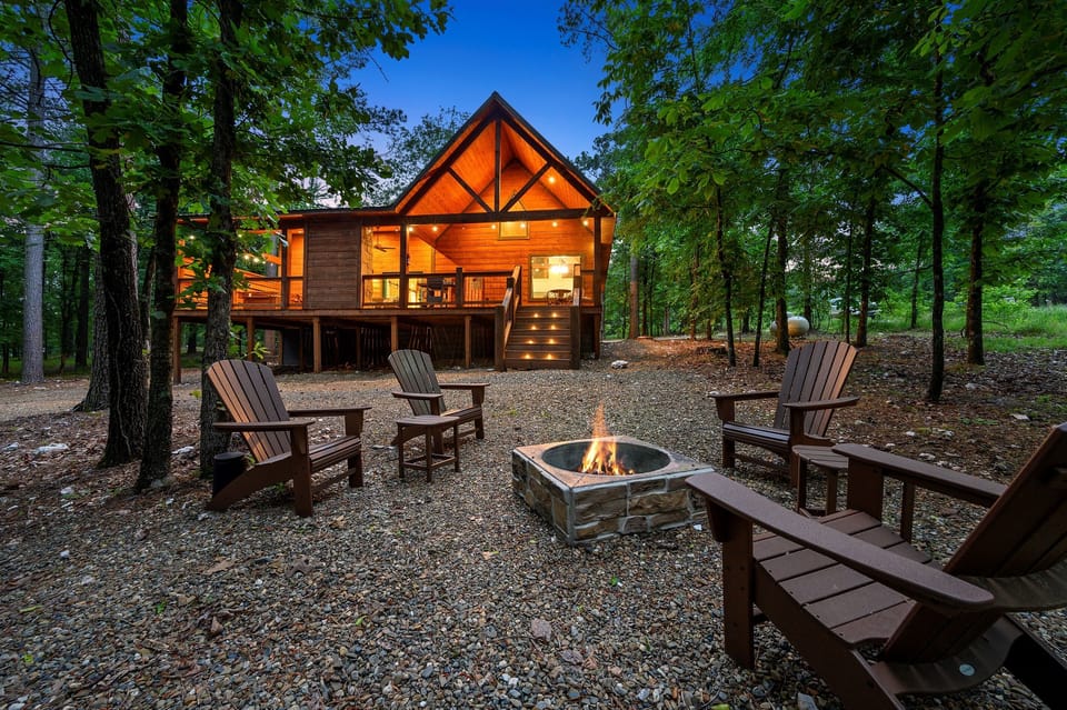 View of the spacious back porch, softly lit for a peaceful setting—perfect for unwinding in this cozy cabin