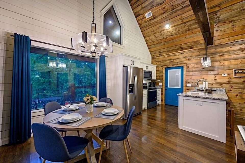 Fully equipped kitchen with stainless steel appliances, including a wine refrigerator