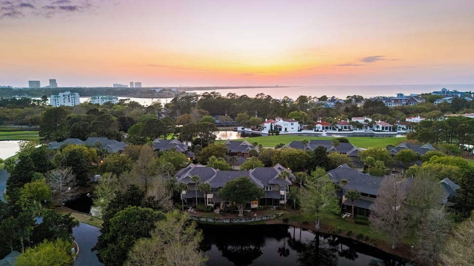 Broad aerial showing full property layout within a premier golf course setting.