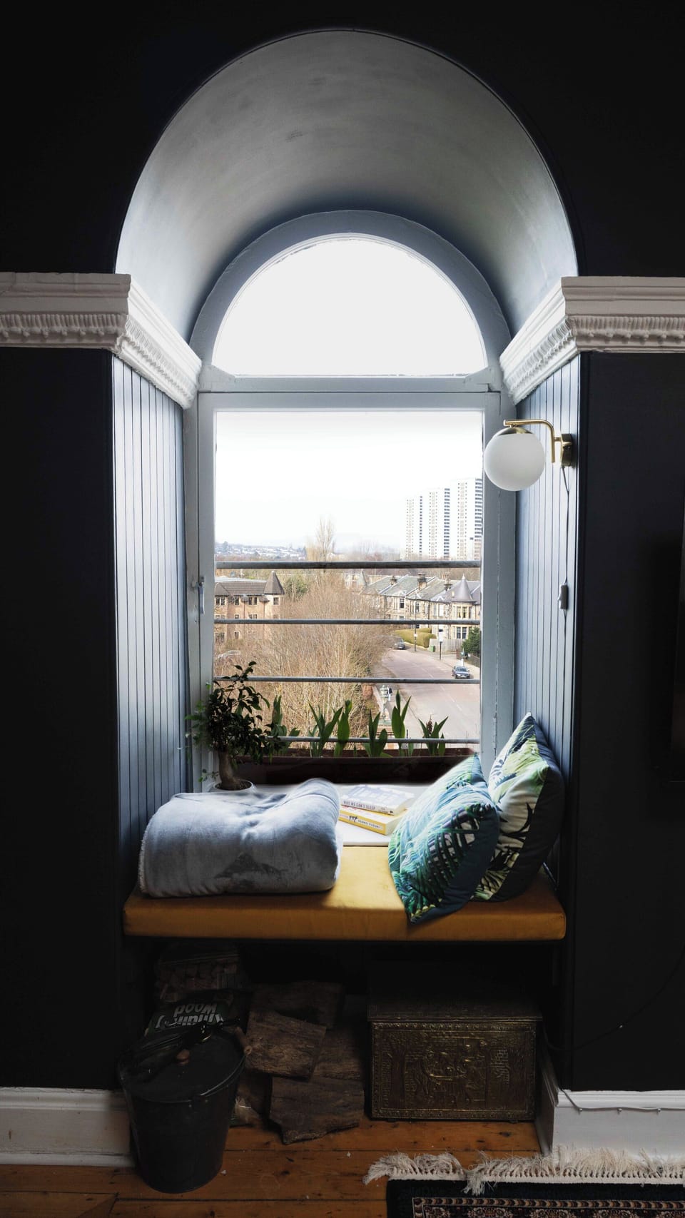 Reading nook in one of 3 arched windows and infront of the fireplace