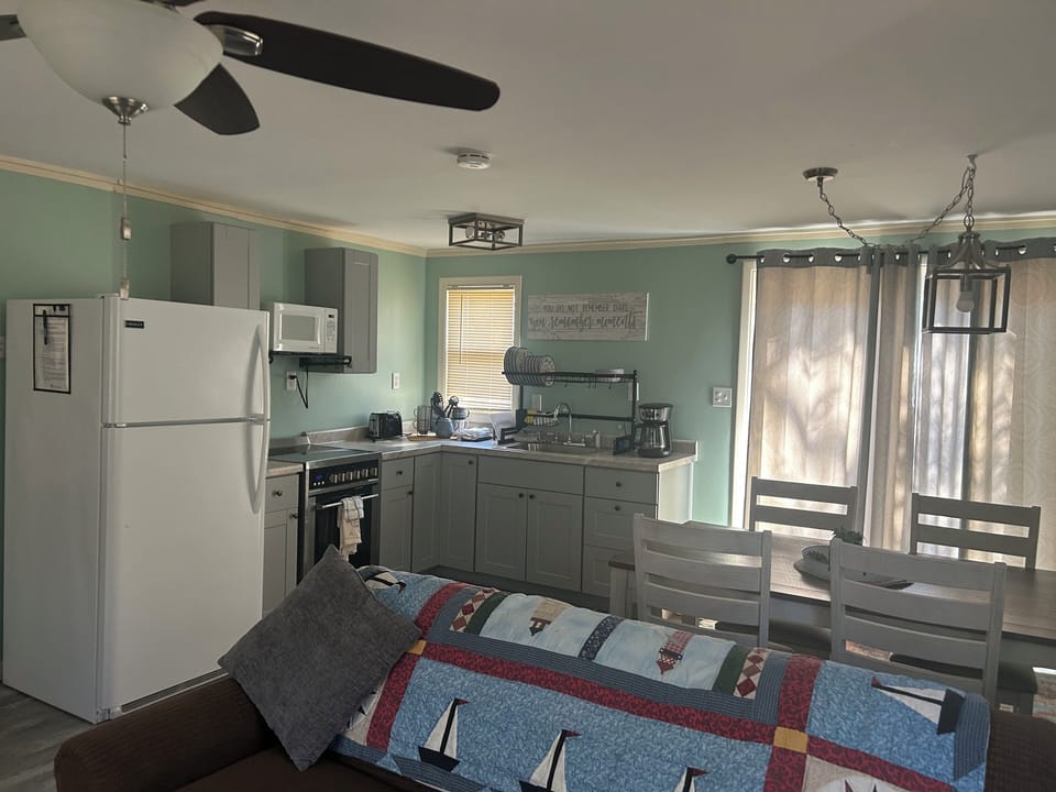LIVING ROOM:  Another view of the living room with the kitchenette and dining area in the background