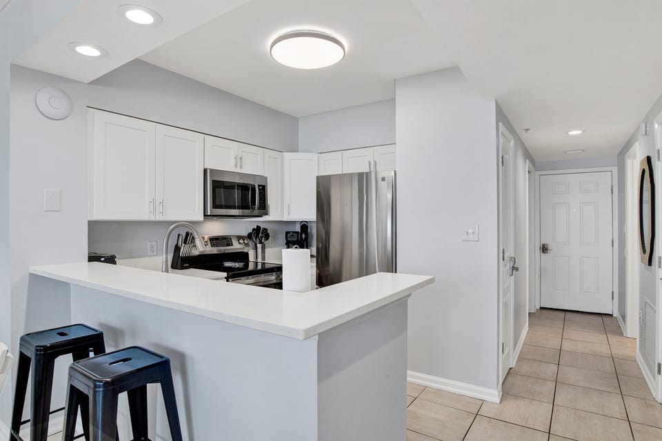 Breakfast bar seating for 2 and kitchen area