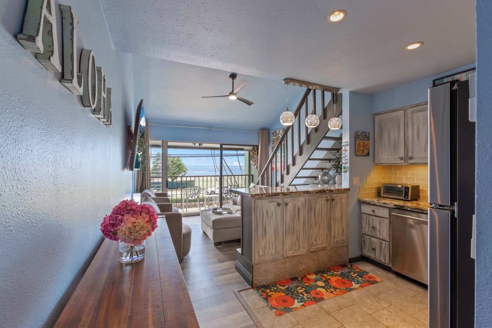 Welcome to your bright and inviting Maui retreat, featuring an open living space with ocean views and a charming kitchen area.