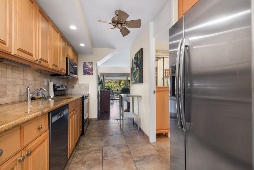 Your fully equipped galley kitchen features granite counters, stainless steel appliances, and everything needed to prepare meals in comfort and style.