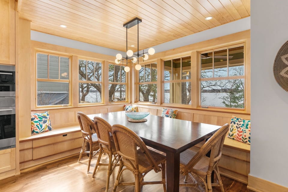 Gather around your cozy breakfast nook with built-in benches and colorful cushions, where warm wood tones and natural light create the perfect spot for morning coffee.