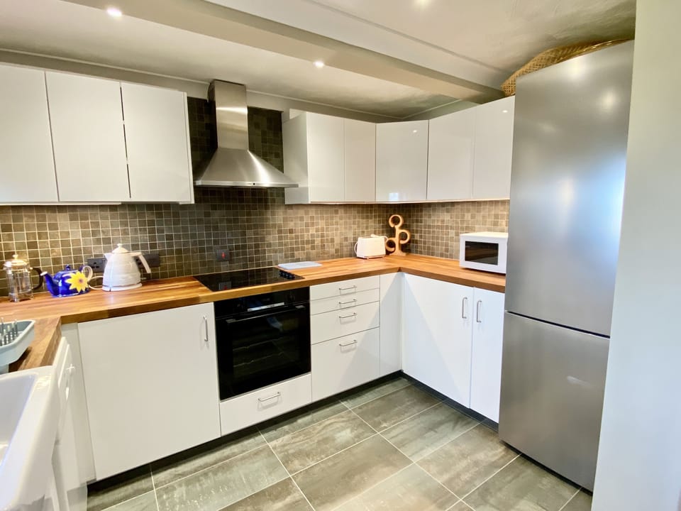 Kitchen and fridge freezer in Morwennol holiday cottage in Harlyn Bay, Padstow, North Cornwall
