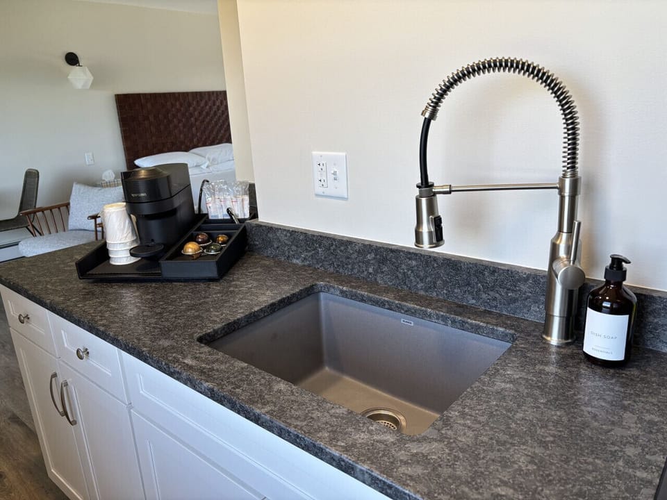 Modern kitchenette with a large sink, Nespresso coffee maker, and convenient counter space for your stay.