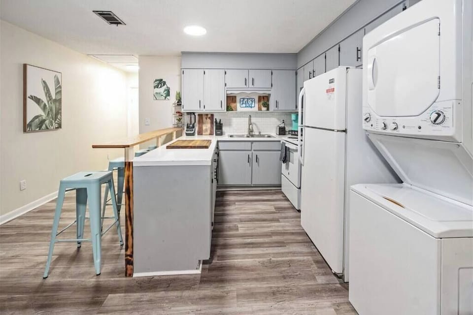 Fully equipped kitchen w/ island seating, modern finishes & plenty of prep space