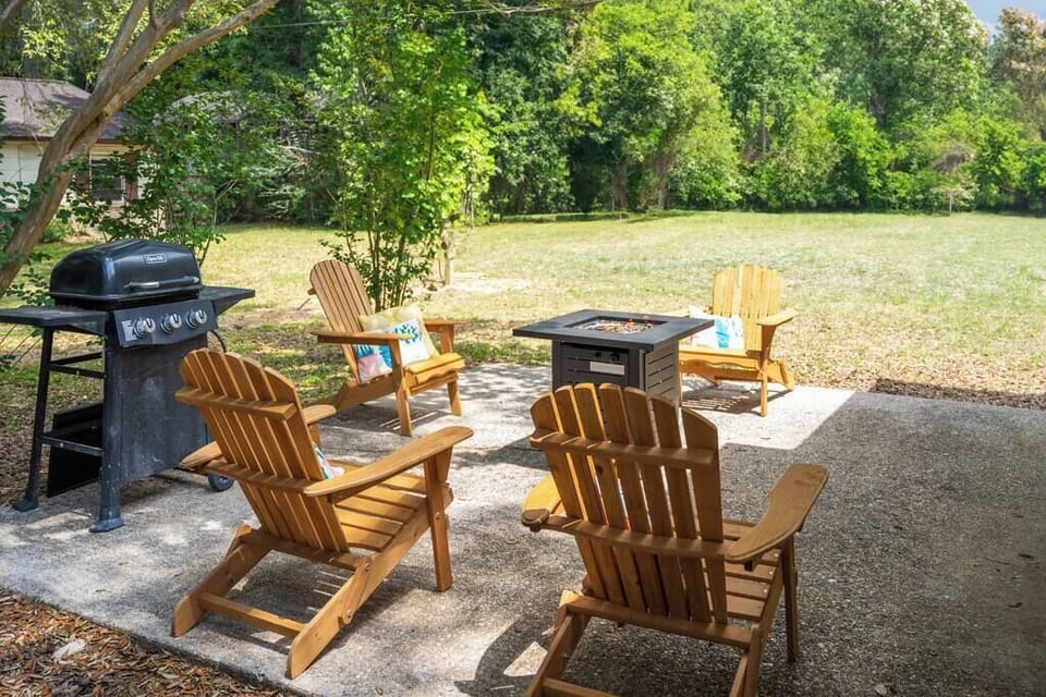 Shaded patio w/ outdoor seating, ideal for alfresco meals surrounded by greenery